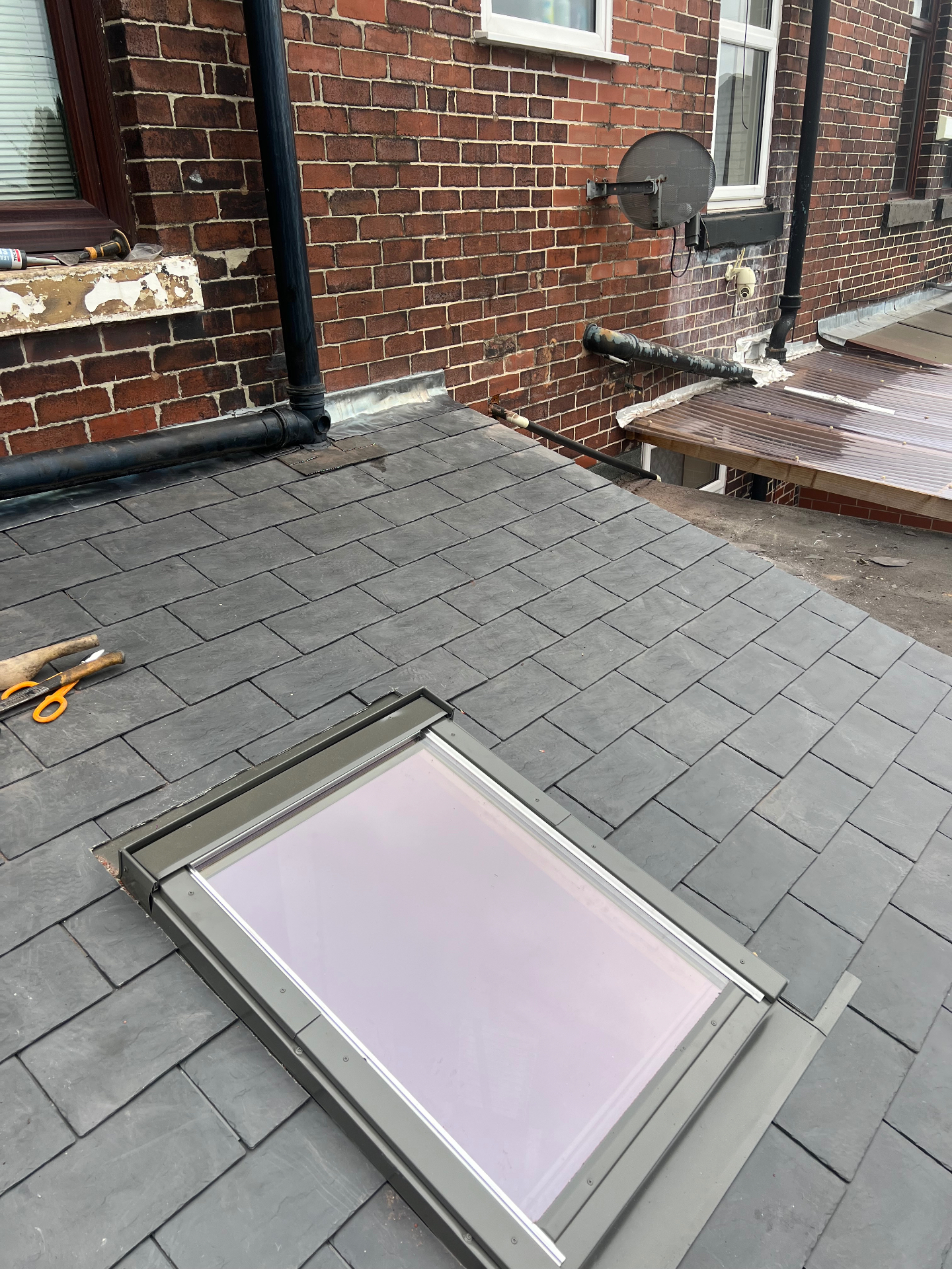 Newly installed synthetic slate roof with skylight fitted for extra natural light